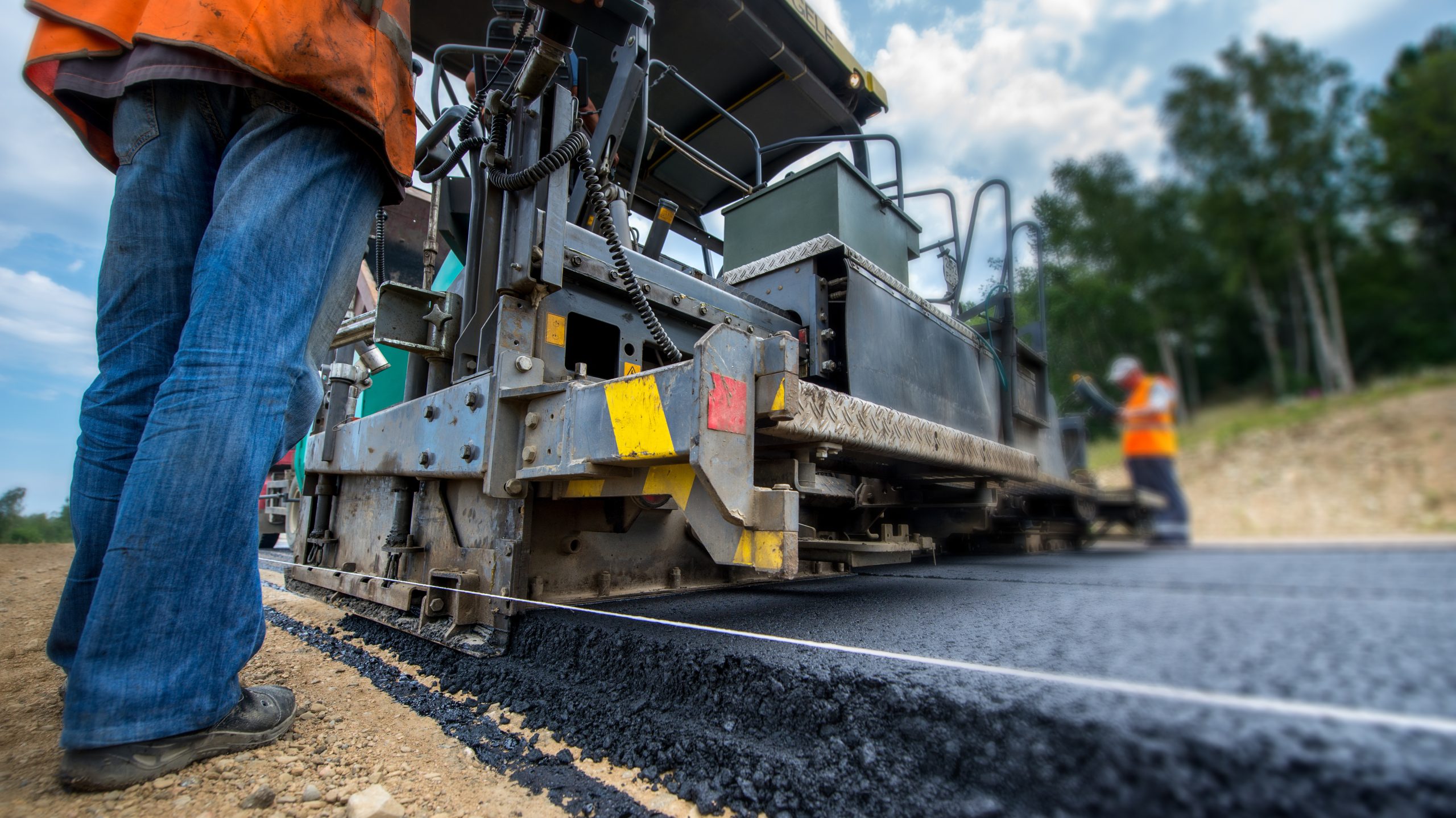 Paving new road with asphalt, road construction