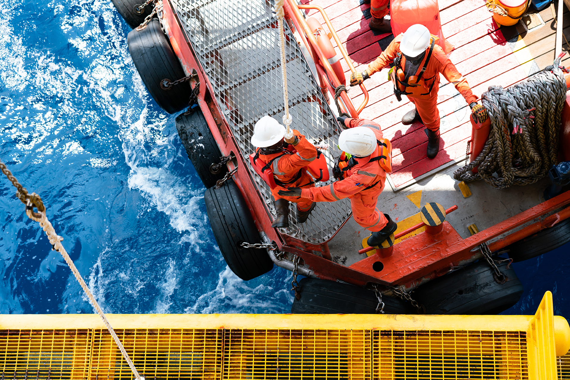 Offshore workers coordinating activity on an energy project, demonstrating safety practices, teamwork, and execution in an EPC environment